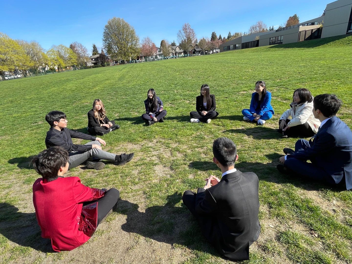 Students in a conversation circle on a lawn, from my TEDx photo collection